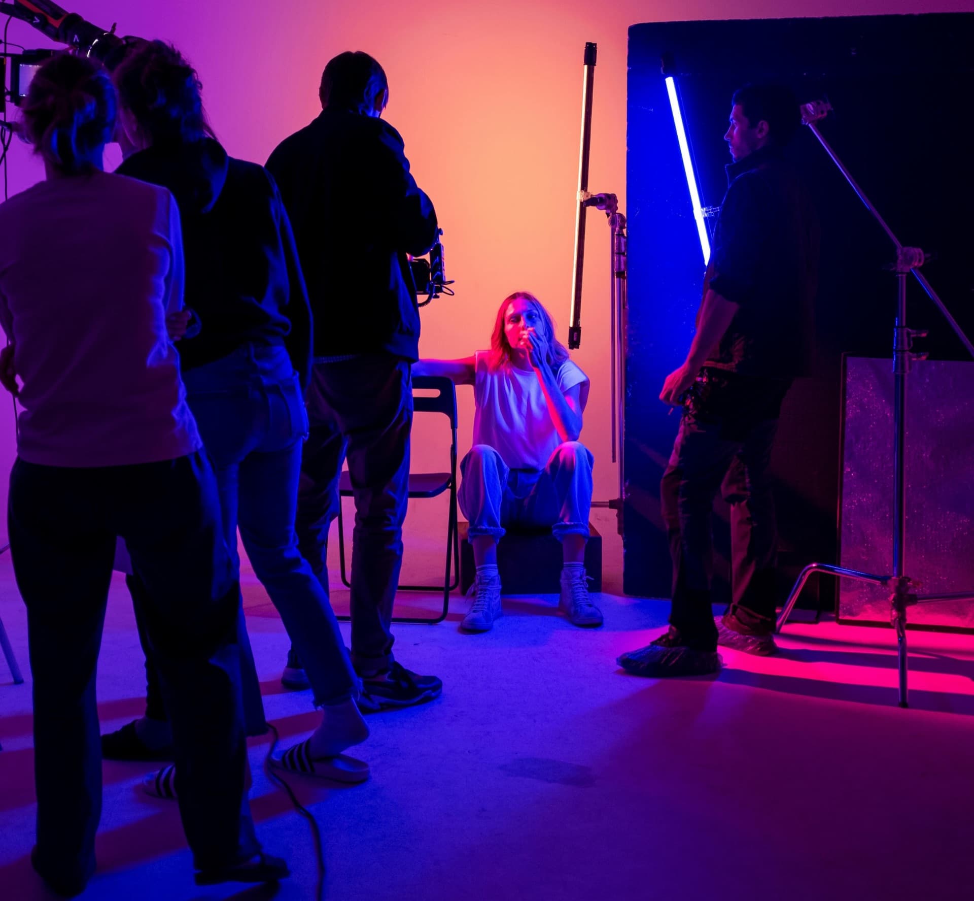 Close-up of a cinema camera viewfinder showing a framed subject on a studio set.